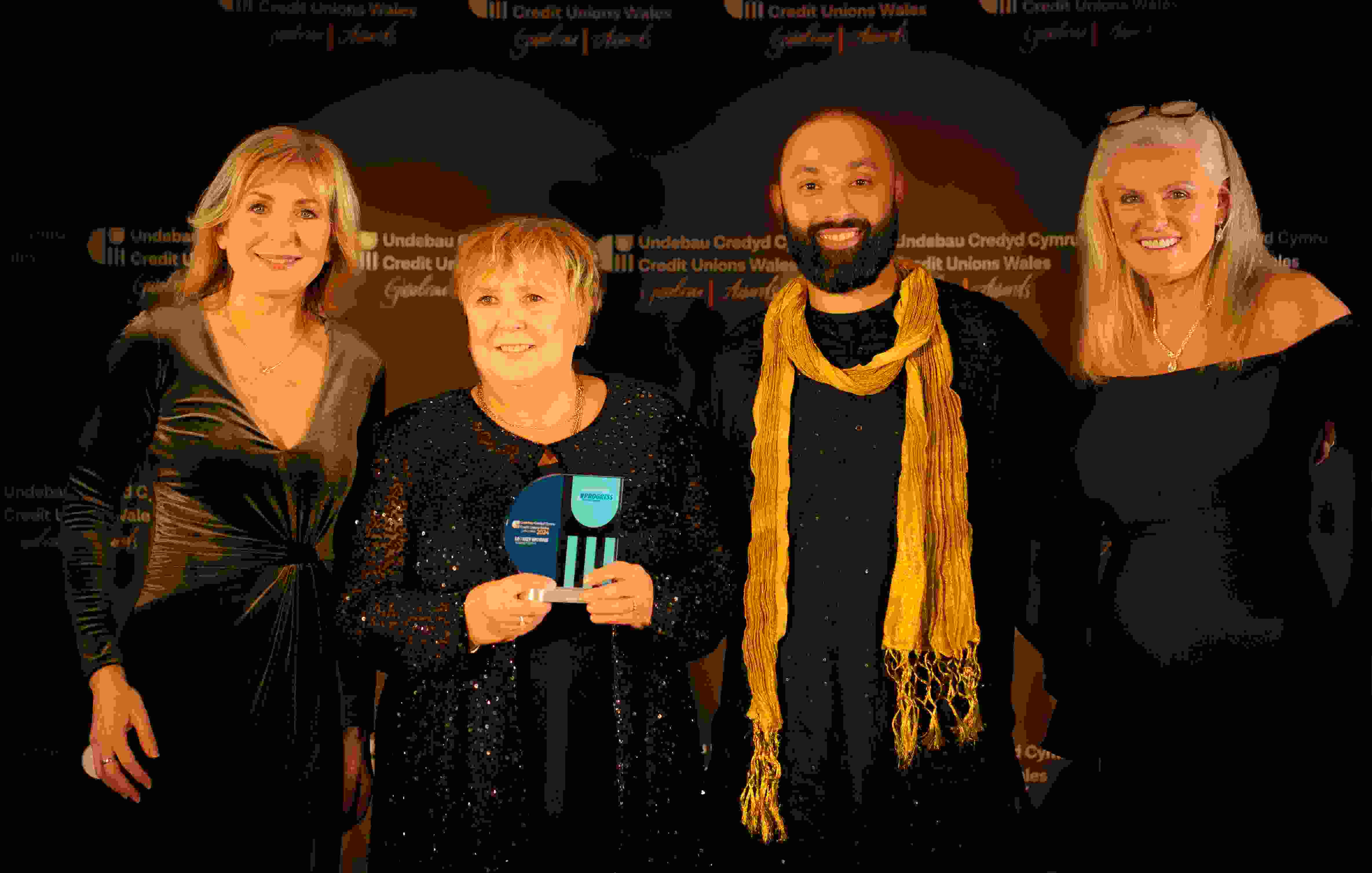 Llinos Jonathan receiving her award, presented by Sian Lloyd, Rizwan Shams, and Sandy Highfield